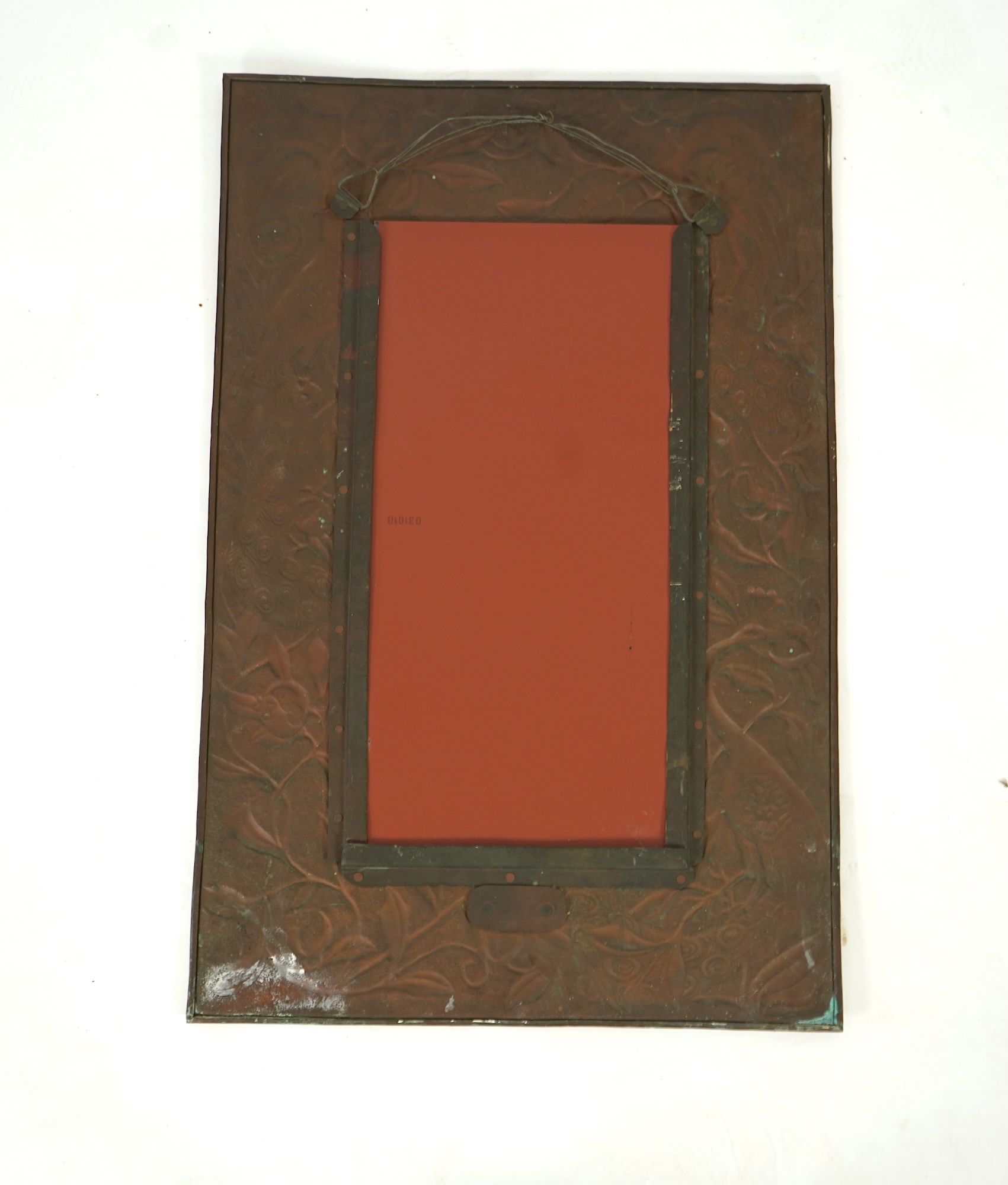 An Arts and Crafts embossed copper mirror, manner of Talwin Morris, Glasgow School